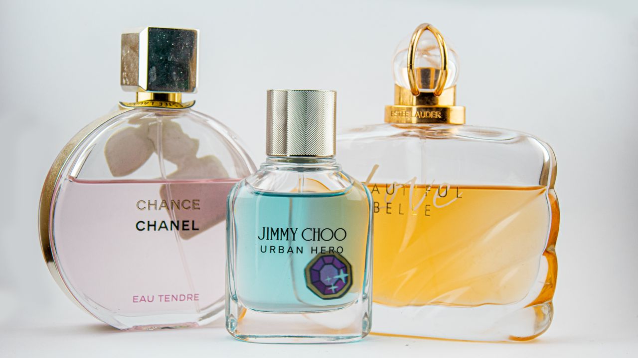 services-01 Elegant display of designer perfume bottles featuring Chanel, Jimmy Choo, and Estee Lauder.